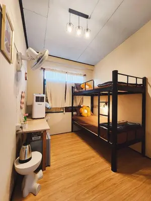 a room with two bunk beds and a desk at 215-Olan Place Free Wi-Fi and Near BTS line in Sathani Bang Khen