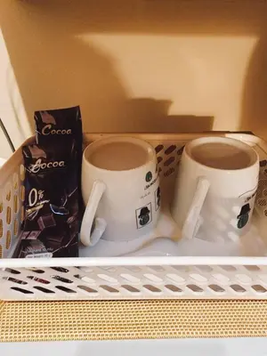 two coffee cups are sitting on a shelf at 215-Olan Place Free Wi-Fi and Near BTS line in Sathani Bang Khen
