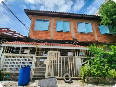 a house with a bird cage in front of it at 215-Olan Place Free Wi-Fi and Near BTS line in Sathani Bang Khen