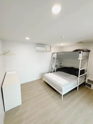 a room with a bunk bed and a desk at Silom Hideaway 27 Floor City View, 4-min to BTS in Bangkok