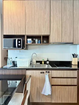 a kitchen with wooden cabinets and a sink at 072-Cap-A-R266-F24 in Ban Na Song