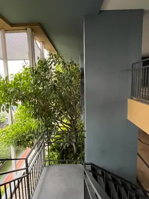 a hallway with plants on the side of a building at Lumpini Park Vibhavadi-Chatuchak in Bangkok