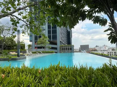 a large swimming pool in a city with tall buildings at Lumpini Park Vibhavadi-Chatuchak in Bangkok