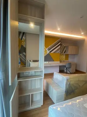 a bedroom with a closet with drawers and a bed at Lumpini Park Vibhavadi-Chatuchak in Bangkok