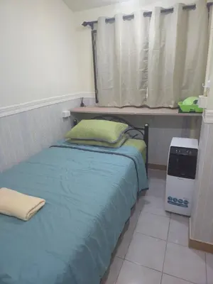 a bedroom with a bed and a window with avertisement at 114 Boutique style apartment with Air Con and free Wi-fi in Bangkok