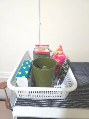 a basket sitting on top of a table with a cup at 114 Boutique style apartment with Air Con and free Wi-fi in Bangkok