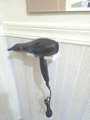 a black hair dryer is hanging from a window at 114 Boutique style apartment with Air Con and free Wi-fi in Bangkok
