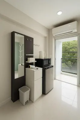 a kitchen with a stove and a sink and a window at Minimal condo 5 mins to mrt Suthisarn in Bangkok