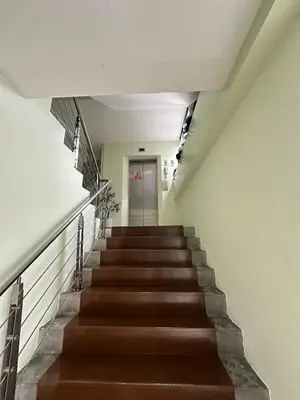 a stairway with brown stairs and a door at Minimal condo 5 mins to mrt Suthisarn in Bangkok