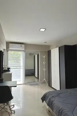 a bedroom with a bed and a desk and a desk at Minimal condo 5 mins to mrt Suthisarn in Bangkok