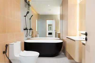a bathroom with a tub and a toilet and a sink at Spacious 4BR Muji Home with Loft Pool in Ekkamai in Bangkok
