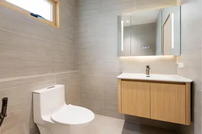 a bathroom with a toilet and a sink at Spacious 4BR Muji Home with Loft Pool in Ekkamai in Bangkok