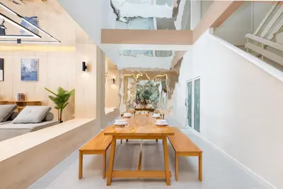 a dining room with a table and a couch at Spacious 4BR Muji Home with Loft Pool in Ekkamai in Bangkok
