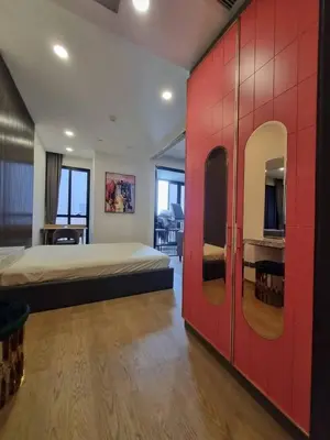 a bedroom with a large bed and a red wall at Ashton Mrt At Bts-Silom Near samyan mitrtown in Bangkok