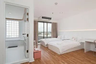 a white bedroom with two beds and a desk at Modern Twin BR Bath & Bathtub Retreat BTS BTB6 in Bangkok