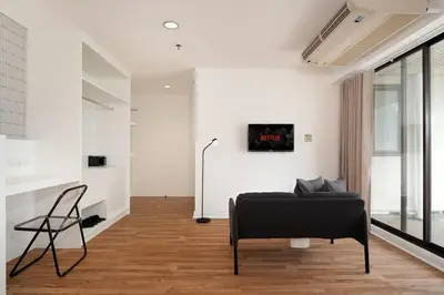 a living room with a couch and a chair at Stylish Twin BR w Ensuite Bath & Relaxing Tub BTB7 in Bangkok