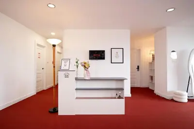 a room with a red carpet and a white wall at Chic King Bed Apt w Bathtub, BTS Central BKK BTB9 in Bangkok