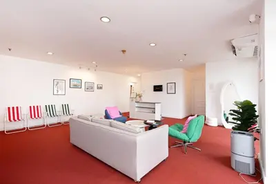 a living room with a white couch and green chairs at Chic King Bed Apt w Bathtub, BTS Central BKK BTB9 in Bangkok