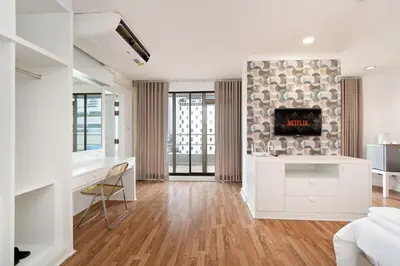 a living room with white furniture and a fireplace at Chic King Bed Apt w Bathtub, BTS Central BKK BTB9 in Bangkok