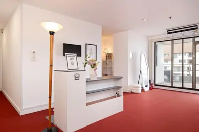 a living room with a red floor and a refrigerator at Chic King Bed Apt w Bathtub, BTS Central BKK BTB9 in Bangkok