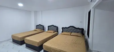 two beds in a room with white walls at Kea House 1- 4BR Vacation house near Airport, Family friendly in Bang Khen