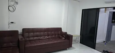 a brown leather couch sitting in a living room at Kea House 1- 4BR Vacation house near Airport, Family friendly in Bang Khen