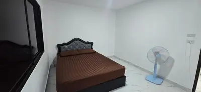 a bedroom with a bed and a fan at Kea House 1- 4BR Vacation house near Airport, Family friendly in Bang Khen