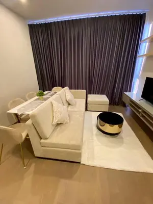 a living room with a white couch and a table at origin phayathai 28 in Bangkok