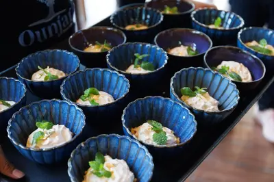 a bunch of small blue cups of food on a table at Little Tree Hut Bangkachao in Bang Chak