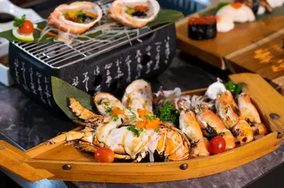 a plate of food with lobster and other foods at Enrich Grand Hotel in Bangkok