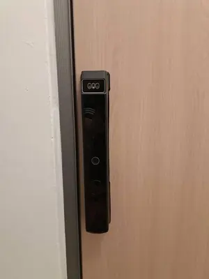 a black remote control is hanging on a door at Brown H in Pom Prap