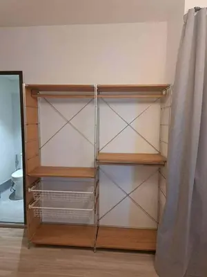 a closet with empty shelves and a curtain at Brown H in Pom Prap