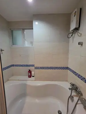 a white bath tub in a bathroom with a window at Super spacious city view apartment close to King Power Mahanakhon Pixel Building Silom Road Patpong Night Market 2 minutes to BTS rail transit bourgeois lifestyle neighborhood in Bangkok