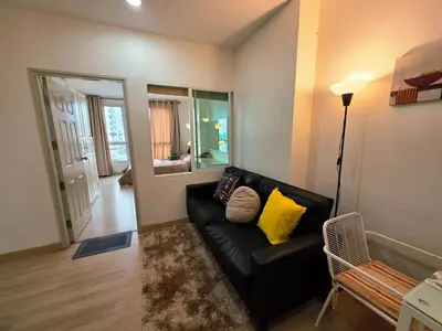 a living room with a black couch and yellow pillows at Super spacious city view apartment close to King Power Mahanakhon Pixel Building Silom Road Patpong Night Market 2 minutes to BTS rail transit bourgeois lifestyle neighborhood in Bangkok