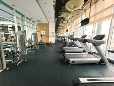 a gym with a row of treadmills and machines at Super spacious city view apartment close to King Power Mahanakhon Pixel Building Silom Road Patpong Night Market 2 minutes to BTS rail transit bourgeois lifestyle neighborhood in Bangkok