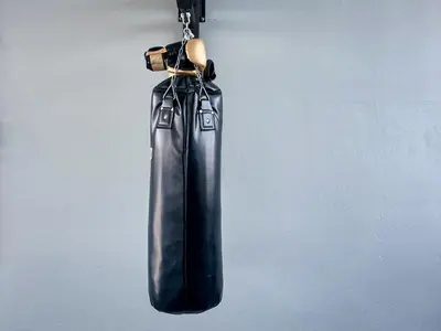 a black bag is hanging on a wall at Nortas Tha Phra in Bangkok