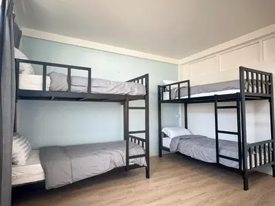 a room with three bunk beds in a room at Nortas Tha Phra in Bangkok