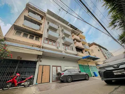 a red motorcycle parked in front of a building at Nortas Tha Phra in Bangkok