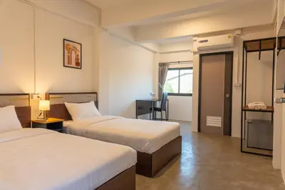 a hotel room with two beds and a bathroom at Morning Place in Ban Krathum Lom
