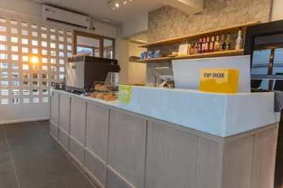 a kitchen with a counter in a restaurant at Morning Place in Ban Krathum Lom
