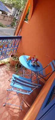 a blue table and two chairs on a balcony at Dar Wafa Riad, Restaurant and Hamam in Bangkok