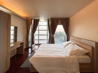 a bedroom with a bed and a large window at Bann-Kun Impact Muang Thong 2BR Condo Wi-Fi MRT Pink Near Airport DM