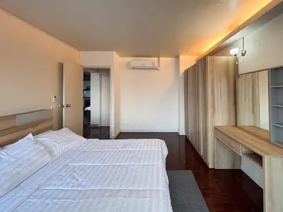 a bedroom with a large white bed and a desk at Bann-Kun Impact Muang Thong 2BR Condo Wi-Fi MRT Pink Near Airport DM