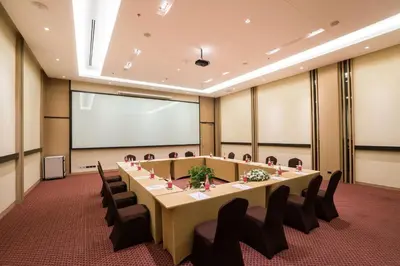a large meeting room with a long table and chairs at Best Western Plus Wanda Grand Hotel in Nonthaburi