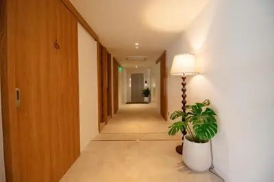 a hallway with a potted plant and a lamp at Marwin Terra Hotel in Bangkok