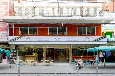a building with tables and chairs in front of it at PSA Palace Khaosan in Bangkok