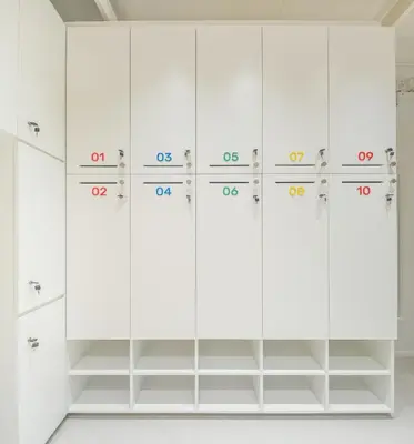 a row of white lockers in a locker room at Bedd Hostel in Bangkok