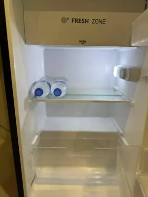 an empty refrigerator with two rolls of toilet paper at 1-Min Walk to BTS Thonglor Simple Spotless Great Value Stay in Khlong Toei
