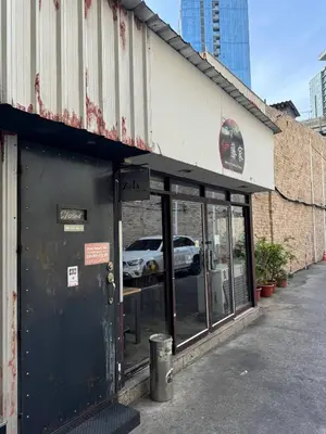 a store front of a building with a car in the window at 1-Min Walk to BTS Thonglor Simple Spotless Great Value Stay in Khlong Toei