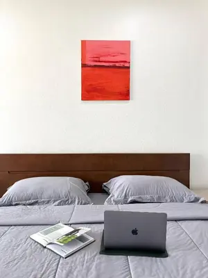 a bed with a laptop and a book on it at 1minBTS-Wifi500Mbs-Workplace>NETFLIX/Central in Khlong Toei